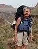 Carol Johnson hiking on a desert trail with a large pack.