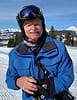 Gary Keiser with ski goggles, helmet, and blue winter coat on ski slopes.