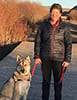 Kathy Fogo walking her husky dog in late fall.