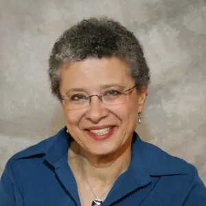 Studio portrait of Noelle Hagan wearing a blue blouse. 