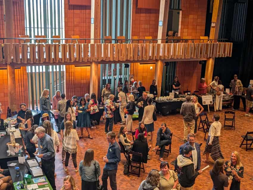 large group of people mingling at nonprofit celebration in the main theater at the Center for the Arts Crested Butte