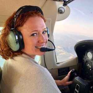 Tanith Martinez wearing a headset in the cockpit of her plane