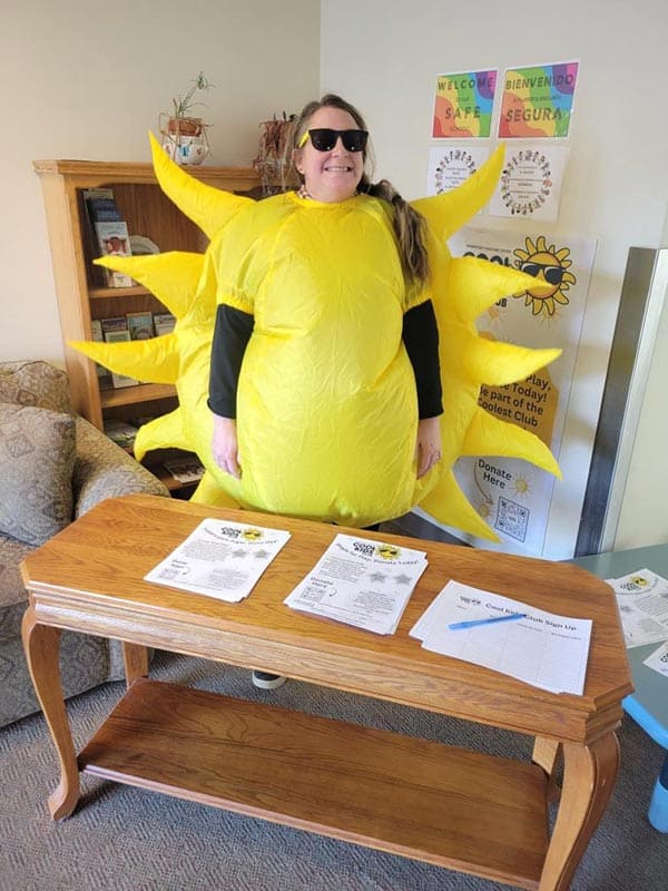 katie-lew Katie Lewinger smiling and wearing sunglasses and a blow-up sun costume