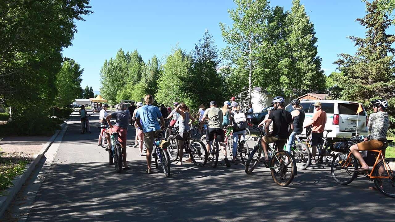 group of bikers following the City of Gunnison's trailer with a band on it